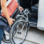 Asian disability woman on wheelchair getting in her car, Accessibility concept.